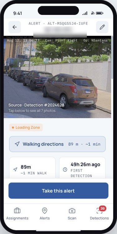 An alert on an officer's phone: the source detection photo, a loading zone tag, the walking distance and a Take this alert button
